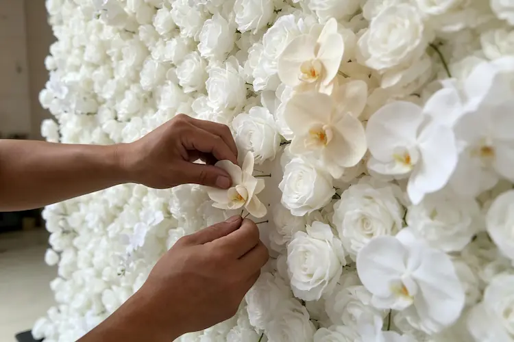 artisan handcrafting silk flower wall backdrop