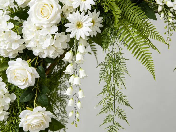 Close-up Detail of Cascading White Roses Hydrangeas Daisies Lily of the Valley and Fern Vines on Wedding Arch