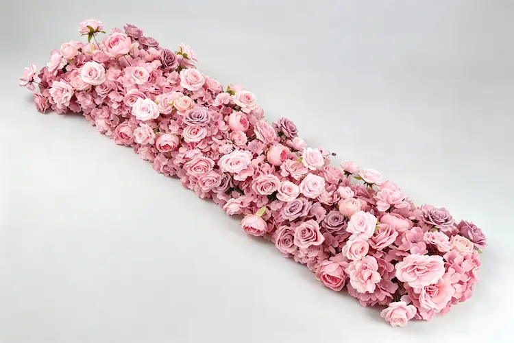 pink artificial flower runner full view flat lay with roses and peonies